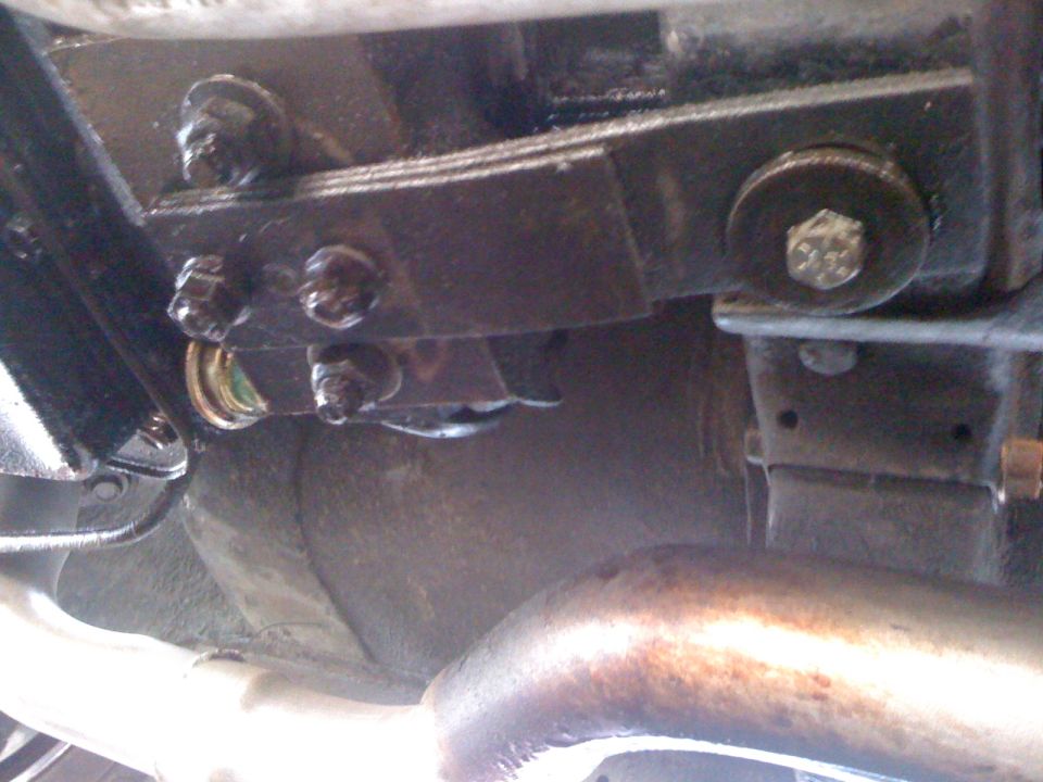 Close-up of a leaf spring with U-bolts and hardware on a vehicle's undercarriage