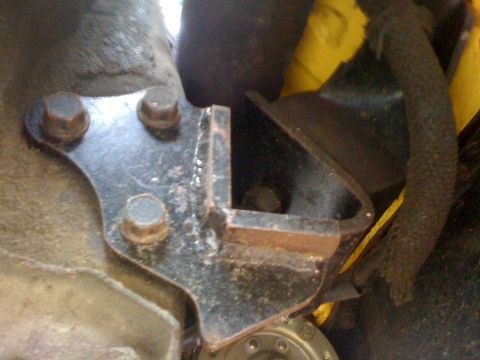1964 Ford Ranchero - Close-up view of a vehicle's engine mount bracket and associated hardware.