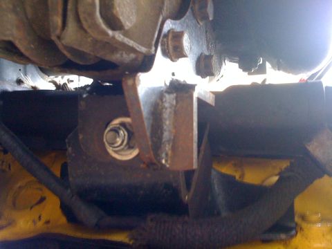 1964 Ford Ranchero - Close-up view of a vehicle's engine mount bracket, showing a bolt and nut securing the assembly.