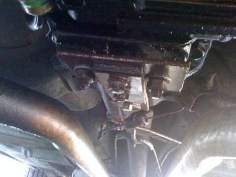1964 Ford Ranchero - This photo shows the underside of a vehicle, focusing on the transmission mount and exhaust system components.