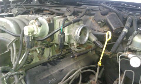1991 Mercury Grand Marquis - Close-up view of an engine bay, highlighting the throttle body and associated components.