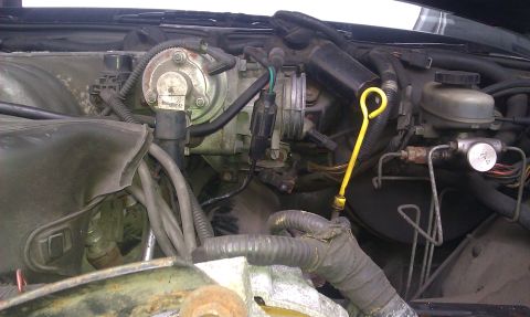 1991 Mercury Grand Marquis - Close-up view of an engine bay, focusing on the throttle body and oil dipstick.