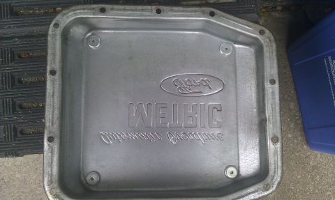1991 Mercury Grand Marquis - Aluminum transmission pan with Ford oval logo and "WELBIC" embossed, likely for a Ford vehicle.