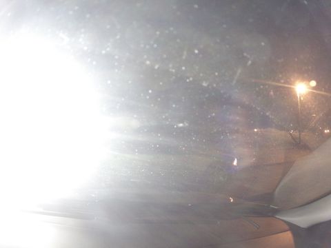 2003 Ford Taurus - Looking out the windshield at night, with bright lights and streetlights visible.