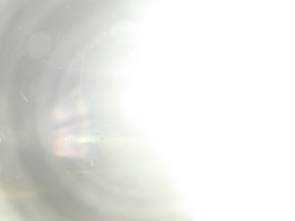 Car interior with bright light glare on the right side. Some dust specks visible
