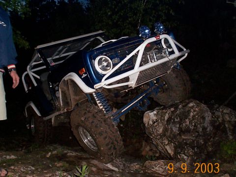 1977 Ford Bronco - This modified 1977 Ford Bronco navigates a rocky trail, its off-road capabilities.