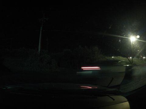 2003 Ford Taurus - The view from the driver's seat at night shows streetlights and motion blur from passing traffic.