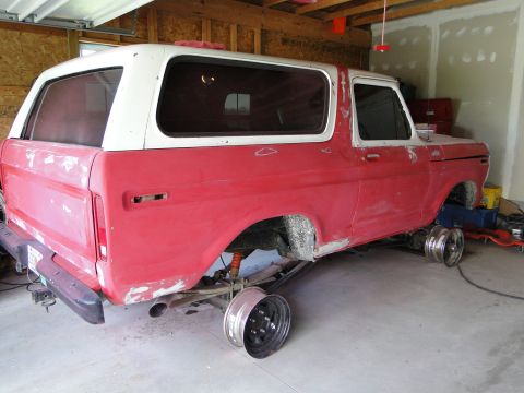 1978 Ford Bronco - This 1978 Ford Bronco is in a garage, lifted on jack stands for restoration work.