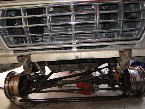 1978 Ford Bronco - Close-up view of the front grille and suspension system of a 1978 Ford Bronco undergoing restoration.