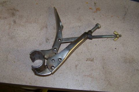 1994 Ford F-150 - A specialized tool, likely for automotive work, locking pliers adapted with a pipe clamp attachment.