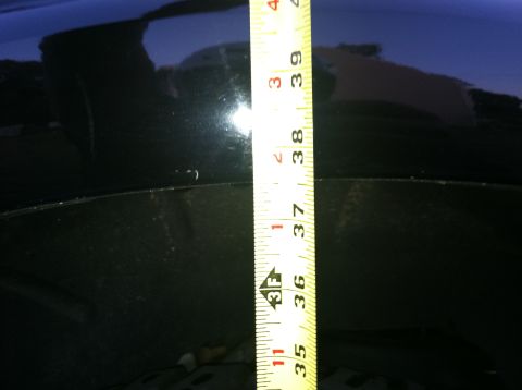 2005 Ford Explorer - A measuring tape is placed against the black body of a vehicle, with no clear year identification visible.