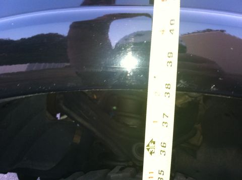 2005 Ford Explorer - A measuring tape is placed against the fender of a black vehicle, indicating a measurement between 36 and 40 inches.
