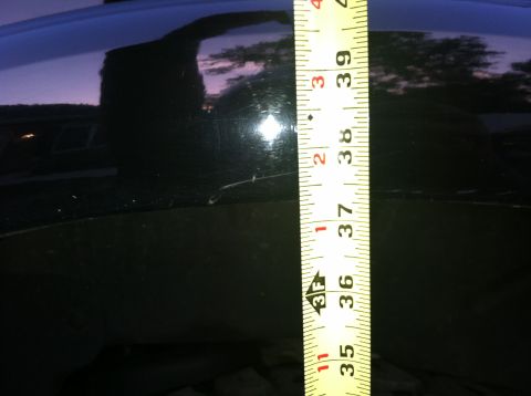2005 Ford Explorer - Measuring the height of a dark surface with a tape measure.