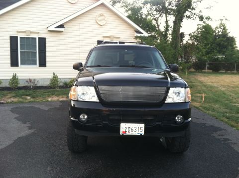 2005 Ford Explorer - Front view of a black Ford Explorer SUV with a custom grille and license plate.