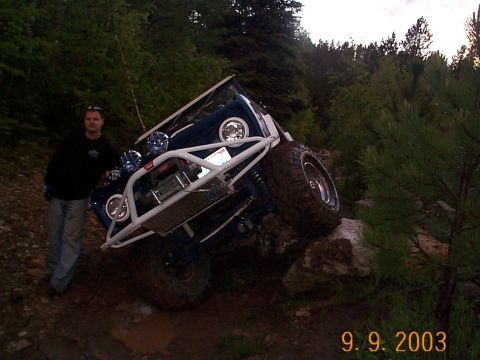 1977 Ford Bronco - A 1977 Ford Bronco is shown off-roading and tilted on rocks.