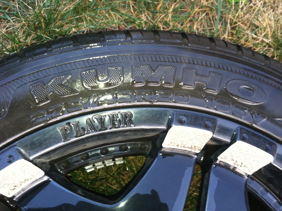 Close-up of a Kumho tire with "PLAYER" written on the rim