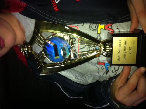 1965 Ford Fairlane - A child proudly holds a hockey trophy awarded in 2012.