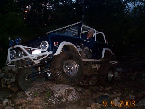 1977 Ford Bronco - This modified 1977 Ford Bronco tackles a challenging rocky trail at night, its off-road capabilities.