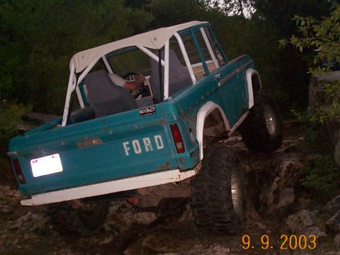 1977 Ford Bronco - This 1977 Ford Bronco is navigating a rocky trail, showing its off-road capabilities.