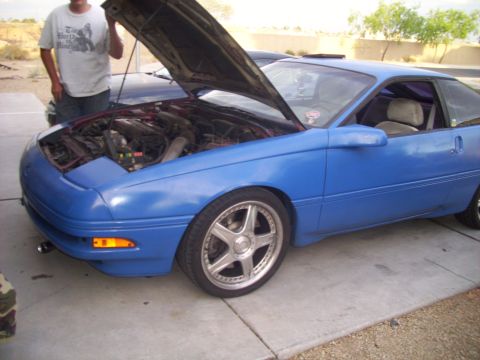 1995 Ford Probe - A blue 1995 Ford Probe is shown with its hood open, revealing the engine compartment.