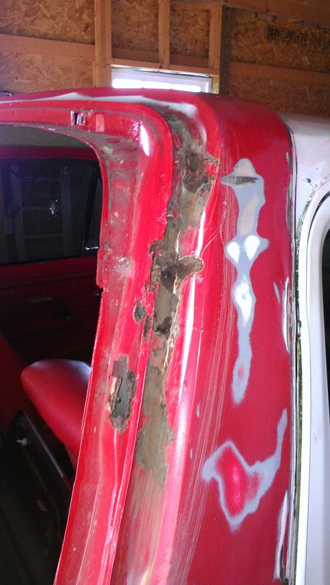 1978 Ford Bronco - The door frame shows extensive rust damage and areas prepared for repair.