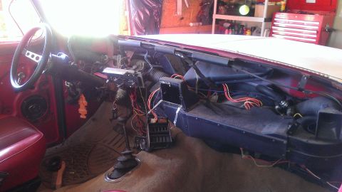 1978 Ford Bronco - The interior of a 1978 Ford Bronco is shown with the dashboard removed, revealing exposed wiring and ventilation components.