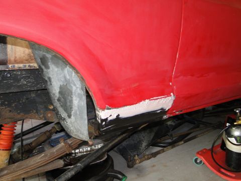 1978 Ford Bronco - Close-up of bodywork being done on a vehicle's lower side panel and wheel arch.