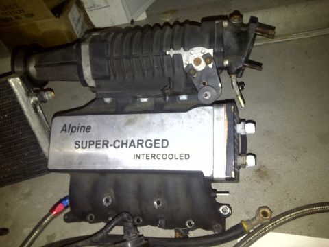 2003 Hyundai Tiburon - Alpine supercharger and intercooler assembly, likely for an engine swap or performance upgrade.