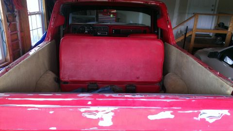 1978 Ford Bronco - Interior view of a red 1978 Ford Bronco, showing the seats and dashboard.