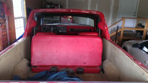 1978 Ford Bronco - The interior of a 1978 Ford Bronco shows a red bench seat and dashboard.