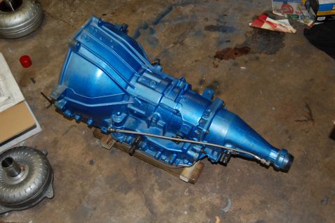 1985 Mercury Grand Marquis - Automatic transmission and torque converter, painted blue, resting on wooden blocks.