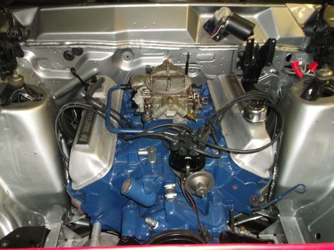1967 Mercury Cyclone - Close-up view of an engine bay, showing the engine block, valve covers, and carburetor.