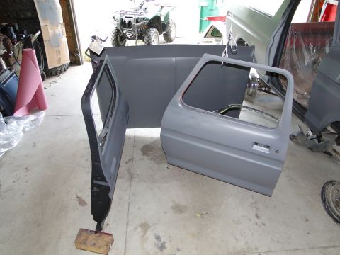 1978 Ford Bronco - Disassembled vehicle doors and bed panel are shown in a garage setting, with an ATV visible in the background.
