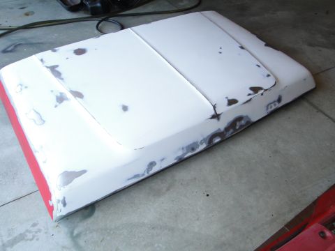 1978 Ford Bronco - Car hood undergoing bodywork, showing areas of primer and filler.