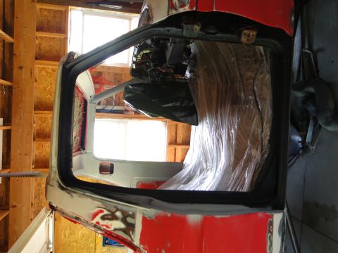 1978 Ford Bronco - Work in progress on a vehicle's interior, showing the door frame and engine bay.