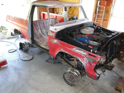 1978 Ford Bronco - This Ford F-Series truck is in a garage with its doors removed and engine exposed, indicating it's undergoing restoration.