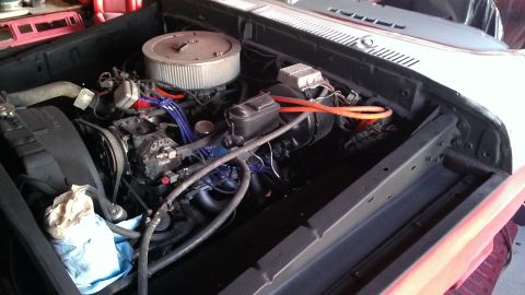1978 Ford Bronco - The engine bay of a vehicle is shown, with various engine components and wiring.