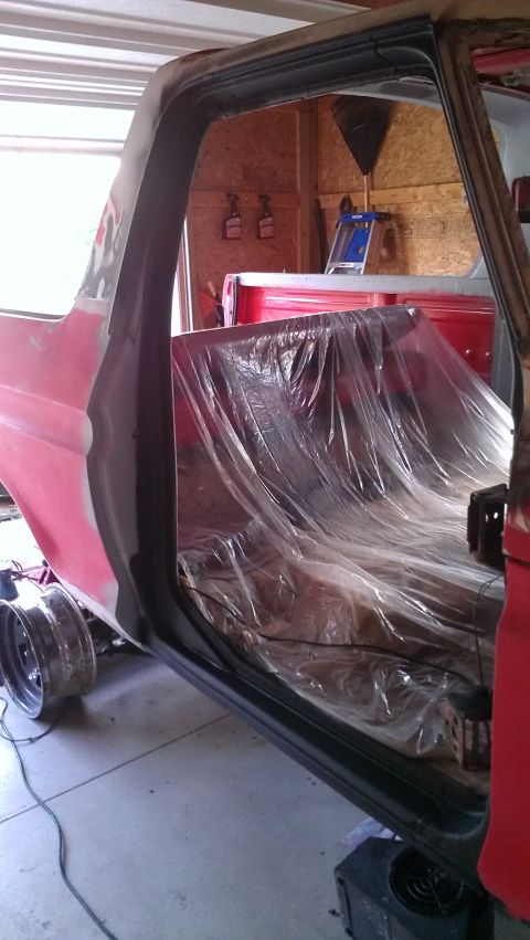 1978 Ford Bronco - The interior of a 1978 Ford Bronco is covered in plastic, suggesting it is undergoing restoration work.