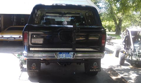 1979 Ford Bronco - Rear view of a black 1979 Ford Bronco, a spare tire carrier and a Michigan license plate.