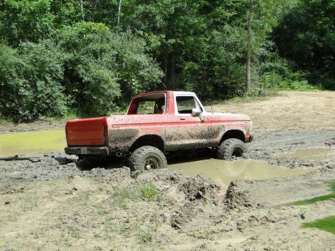 1978 Ford Bronco - This 1978 Ford Bronco is deep in the mud, navigating a challenging off-road course.