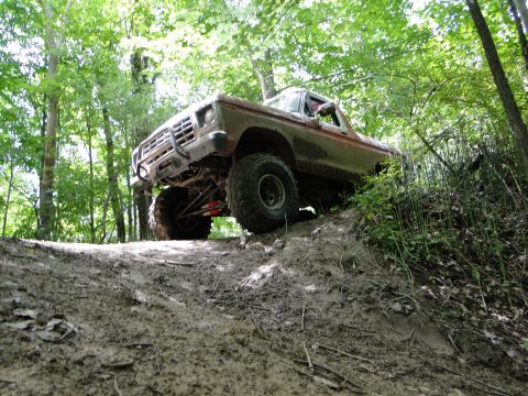 1978 Ford Bronco - This 1978 Ford Bronco is navigating a challenging muddy trail through the woods.