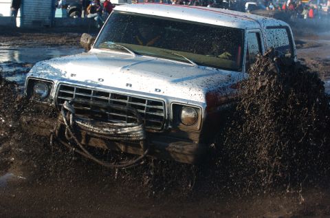 1978 Ford Bronco - This vehicle is deep in the mud, with a winch cable attached to the front.