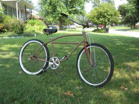 1994 Ford Bronco - A vintage-style cruiser bicycle sits on a grassy lawn in front of a house.
