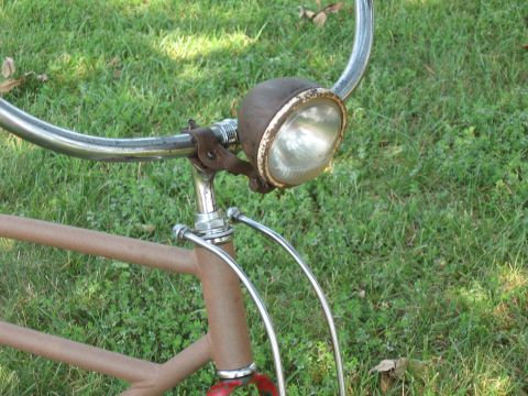 1994 Ford Bronco - This old bicycle headlight shows signs of rust and wear, mounted on a vintage bike frame.