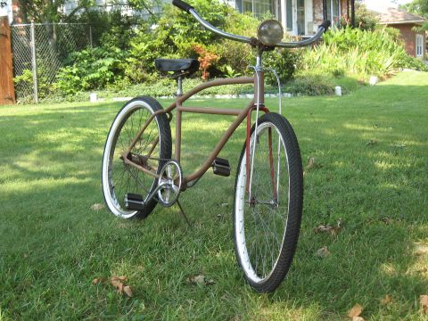1994 Ford Bronco - Cruiser bicycle with whitewall tires and a headlight sits on a grassy lawn.