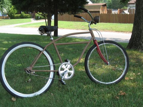 1994 Ford Bronco - A custom cruiser bicycle with a brown frame and whitewall tires sits on a grassy lawn.