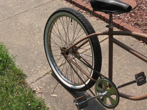 1994 Ford Bronco - A bicycle's rear wheel, frame, and pedals are visible in this close-up shot.