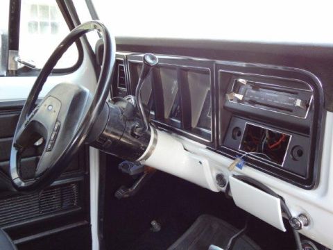 1978 Ford Bronco - The dashboard of a vehicle is shown, with exposed wires visible below the radio.