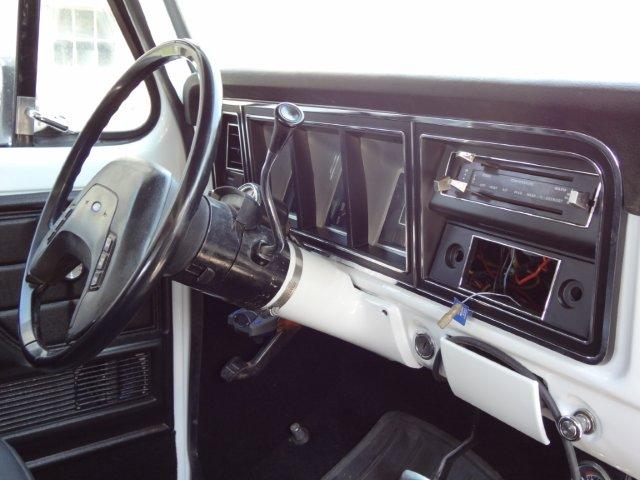 Interior shot of a vehicle's dashboard, showing the steering wheel, radio, and climate controls