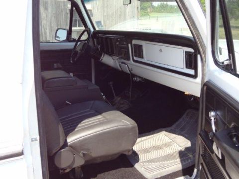 1978 Ford Bronco - The interior of a 1978 Ford Bronco shows a bench seat, dashboard, and floor mats.